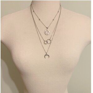 Elegant Layered Silver Necklace with Globe, Rings and Crescent Moon Charm